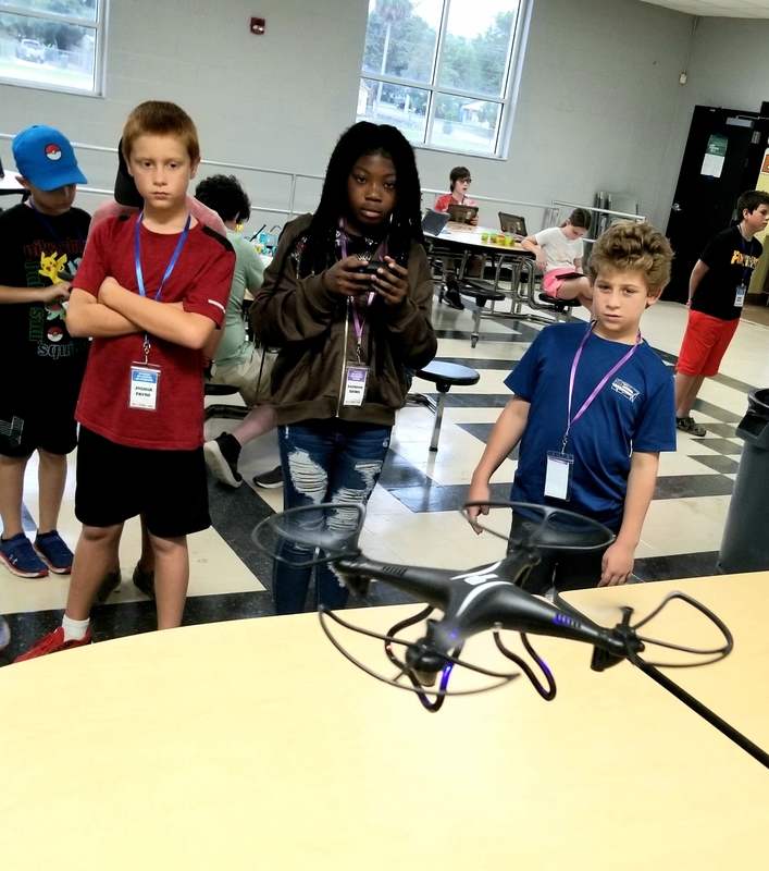 Fifth and sixth graders learn how to pilot a drone.