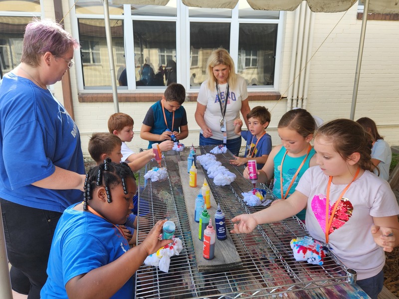 Second graders learn about the science behind using ice to make tie-dyed T-shirts.